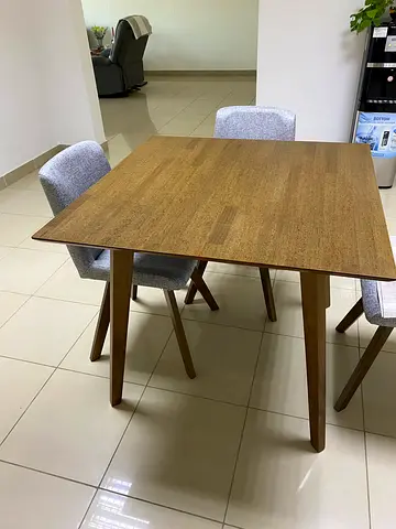 Wooden dining table with 4 grey upholstered chairs