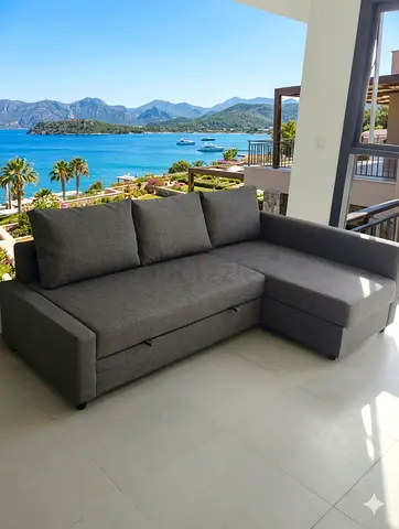 Grey L-shaped sofa bed with chaise - good condition