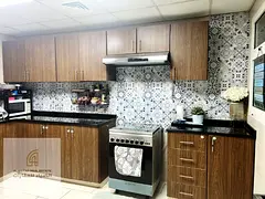 For sale: Two-bedroom apartment with a living room in Al Majaz, overlooking Al Qasba Canal, with par