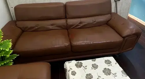 Brown leather 3-seater sofa with matching ottoman — well kept
