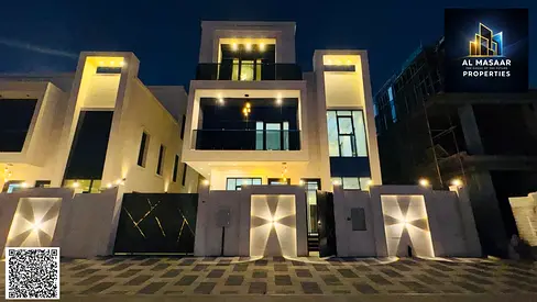 Luxury villa for sale in Ajman, elegant design with swimming pool and elevator. Price includes water, electricity, and ownership.