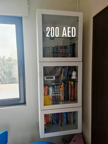 White wall-mounted bookcase with glass doors (3 sections)، 3 curtains different sizes and TV Unit