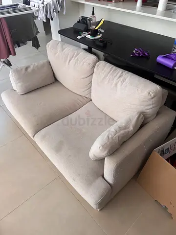 Beige 2-seater fabric sofa - used, some stains