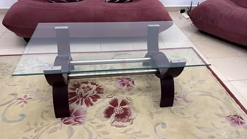 Glass coffee table with curved dark wood legs and lower shelf- Home Center -Excellent condition
