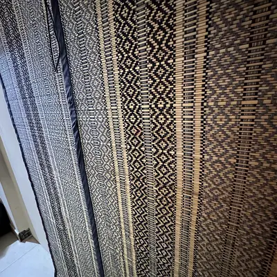 Woven bamboo roll-up blind — natural patterned shade
