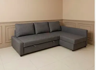 Grey L-shaped sofa with chaise and storage - good condition