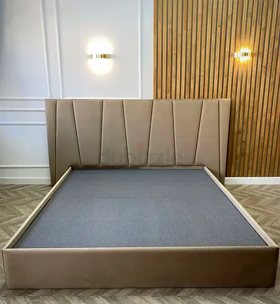 Upholstered platform bed frame with tall padded headboard