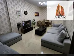 A furnished one-bedroom apartment with a living room located in Orient Towers, offering a comfortabl