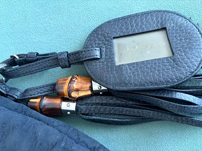 Gucci leather shoulder bag with bamboo handles and luggage tag original price 4500/-