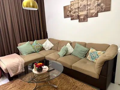 My L-shaped beige and brown sectional sofa and glass center table— great condition