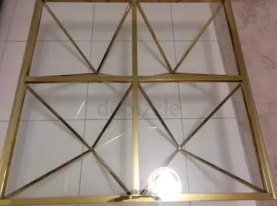 My square glass-top coffee table with gold metal frame