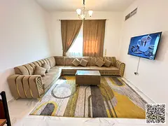 Luxury one-bedroom apartment with a living room and balcony offering an open view. Ajman, Al Rashidi