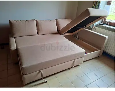 My beige L-shaped sofa bed with hidden storage — converts to double bed