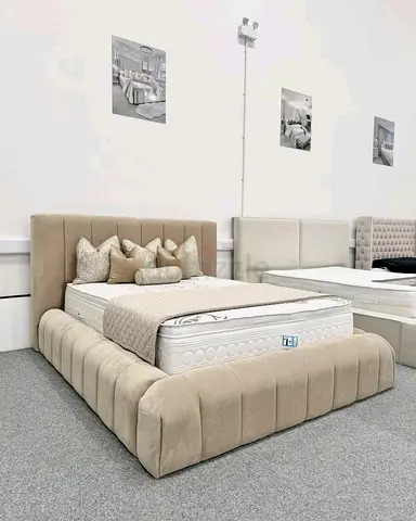 Light beige upholstered bed frame with plush padded headboard