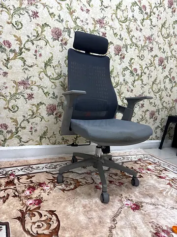 Ergonomic grey office chair with headrest — used, good condition