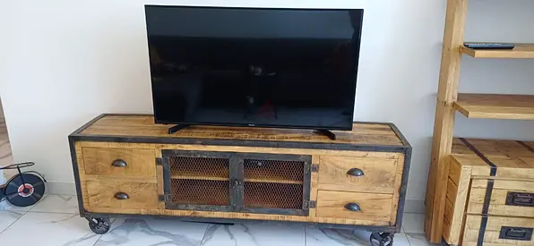 Industrial solid wood TV console with vintage metal mesh doors and castor wheels