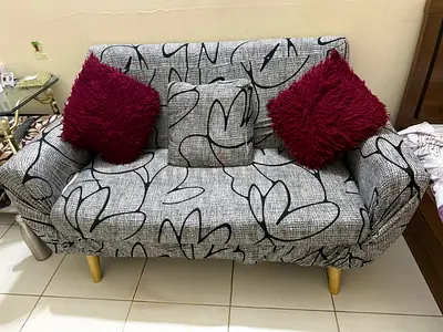 Compact 2-seater sofa with gray patterned slipcover