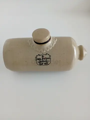 Vintage stoneware bottle with stamped logo and stopper