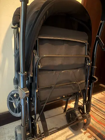 Black pram stroller — folds compact, good condition