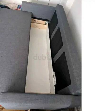 Grey upholstered sofa with under-seat storage