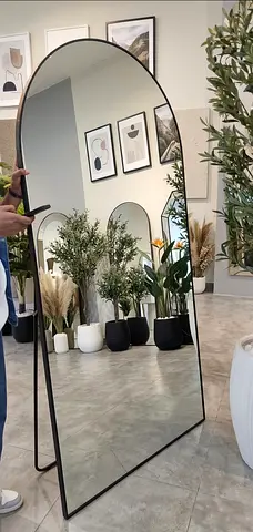 Full-length arched floor mirror with black metal frame