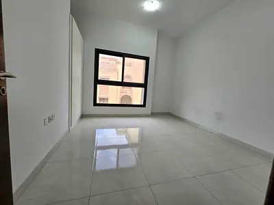 Two-bedroom apartment with a living room - Al Nuaimiya 1, Ajman - Family accommodation - Central air conditioning - 2 bathrooms