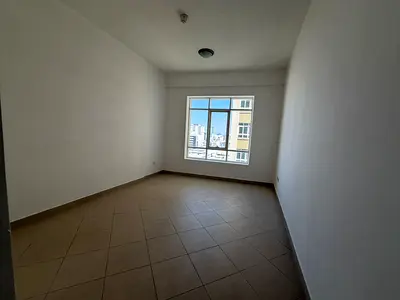 Free parking, 2BR hall + maid, spacious, family tower, balcony open view, flexible, free maintenance, prime location, near Dubai exit