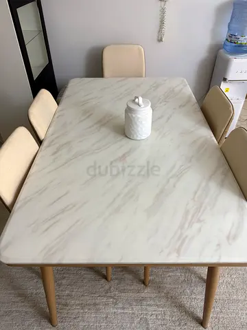 5-seater dining table with faux marble top and upholstered chairs