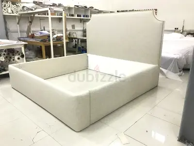 Beige upholstered bed frame with tall headboard