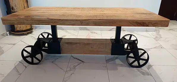 Industrial reclaimed wood dining table with metal wheelbase