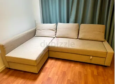 My beige L-shaped sofa with chaise and under-seat storage — good condition