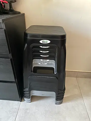 Set of 6 black stackable plastic stools — used, good condition