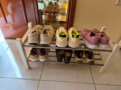 Shoe rack with wooden frame and metal bars - used