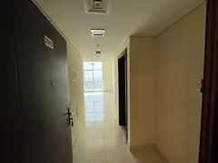 Free parking + gym, pool &amp; kids area | 1BR, hall, 2 baths, built-in wardrobes | Open view of Al 