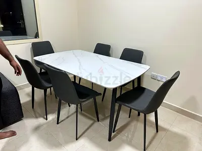 Comfortable cushioned chairs with soft fabric, designed for long and relaxing dinners.