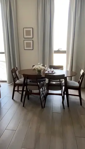 Dinner table set in dark wood.