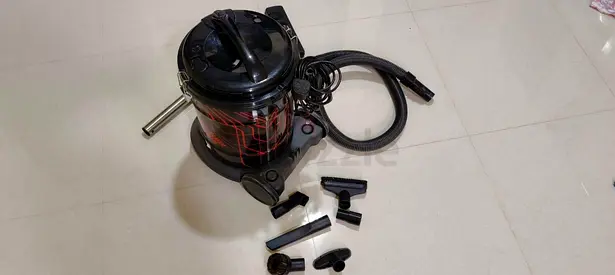 Used canister vacuum cleaner with multiple attachments
