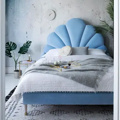 Light blue velvet bed with shell headboard