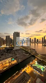 An apartment in Al Khan featuring a direct view of Al Khan Lake and another view of the Qasba Canal.