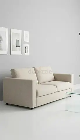 Beige 2-seater fabric sofa - bed