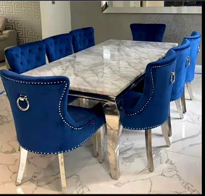 Marble-top dining table with 8 blue velvet chairs