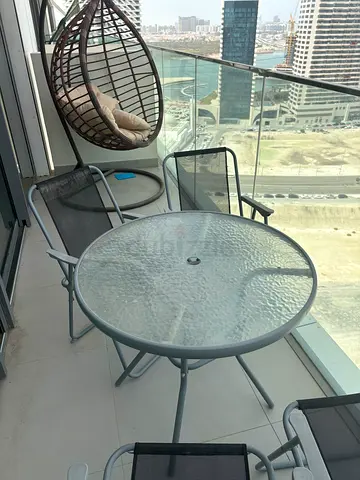 Glass-top balcony table with 4 outdoor chairs