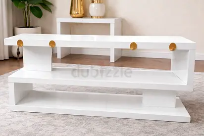 My white glossy modern TV console with gold accents