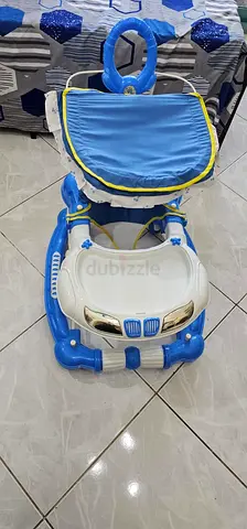 Blue car-themed baby walker with canopy and tray - used