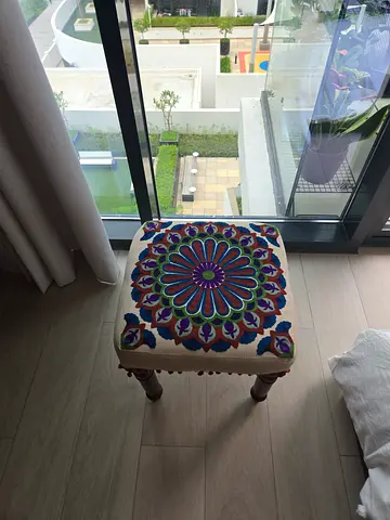 Embroidered footstool with wooden legs