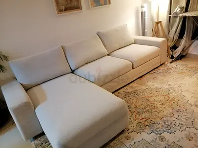 Beige L-shaped fabric sofa bed with chaise