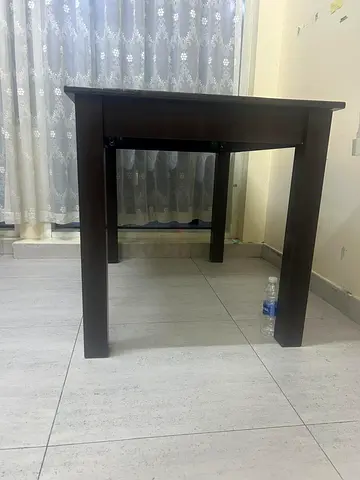 My dark brown wooden dining table — sturdy 4-seater