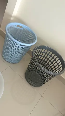 Two plastic laundry baskets — light blue and grey (used)