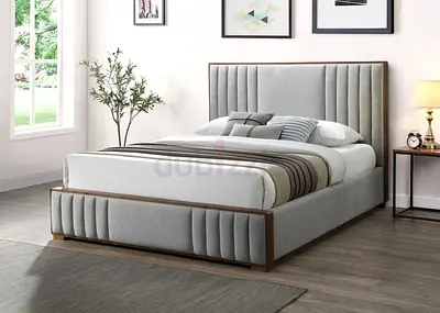 Grey upholstered bed frame with channel headboard and wooden trim