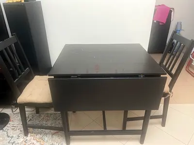 Compact dark wood drop-leaf dining table with 2 chairs